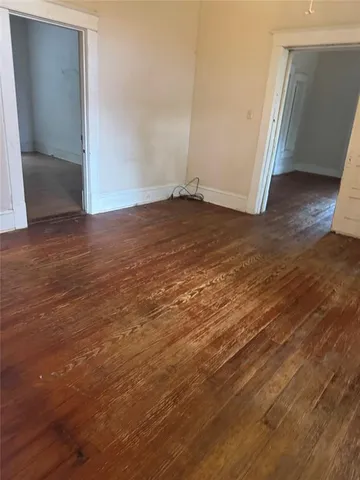 an empty room with wooden floor