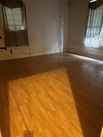 a view of room with window and wooden floor
