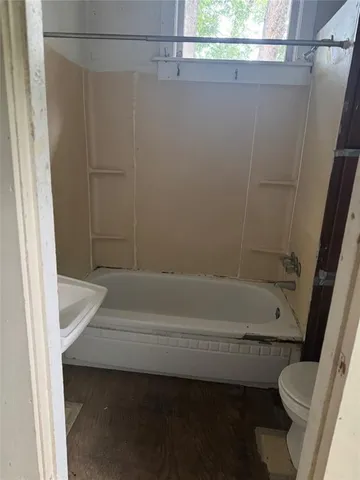 a bathroom with a shower and a toilet