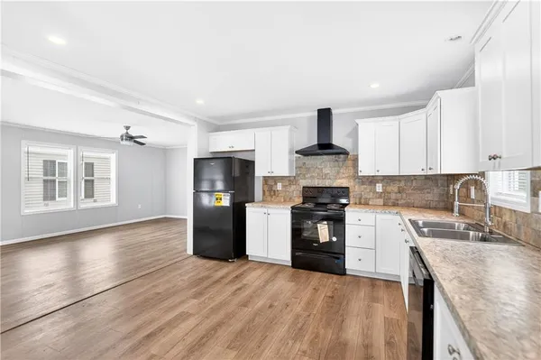 a kitchen with stainless steel appliances granite countertop a refrigerator stove top oven and sink