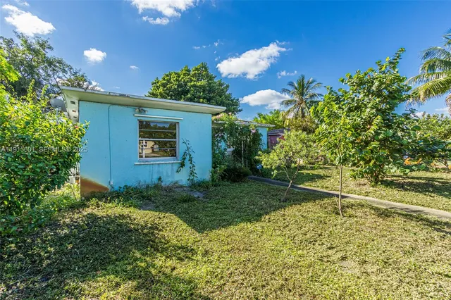 an aerial view of residential houses with outdoor space and street view