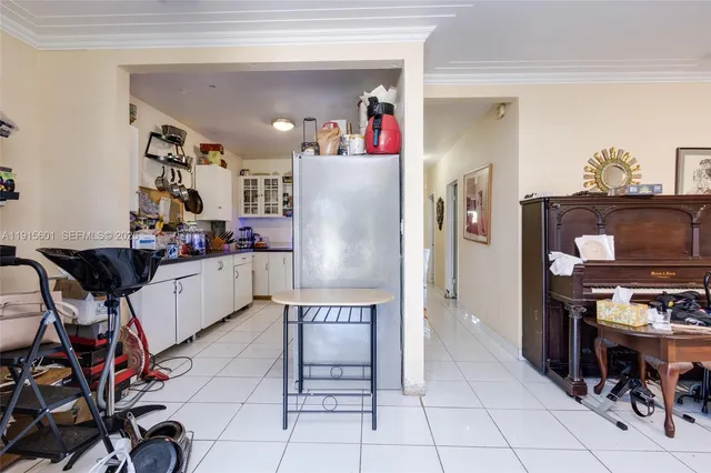 a kitchen with stainless steel appliances granite countertop a refrigerator and a stove