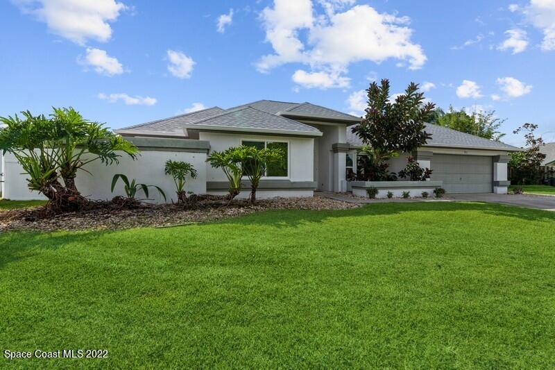 a front view of house with a garden