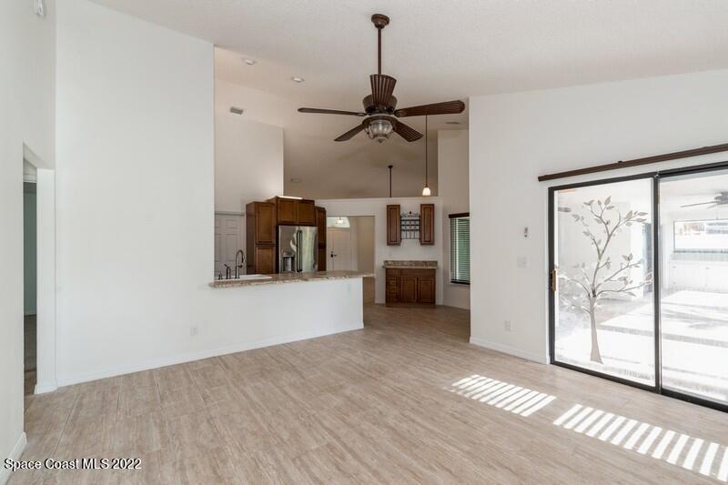 711 Montclair Road Northeast Palm Bay, FL 32905 - Photo 15 of 35 a view of a room with wooden floor closet and windows