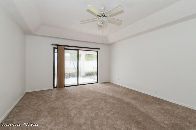 711 Montclair Road Northeast Palm Bay, FL 32905 - Photo 17 of 35 an empty room with a ceiling fan and a window