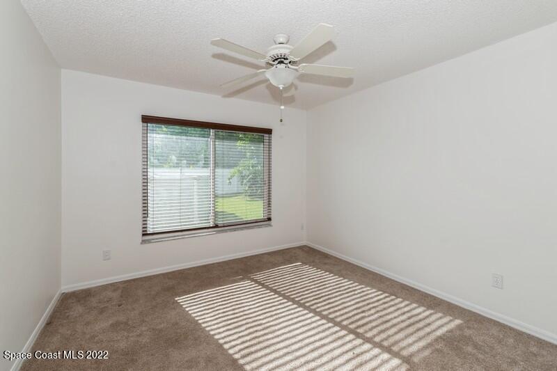711 Montclair Road Northeast Palm Bay, FL 32905 - Photo 23 of 35 an empty room with a window