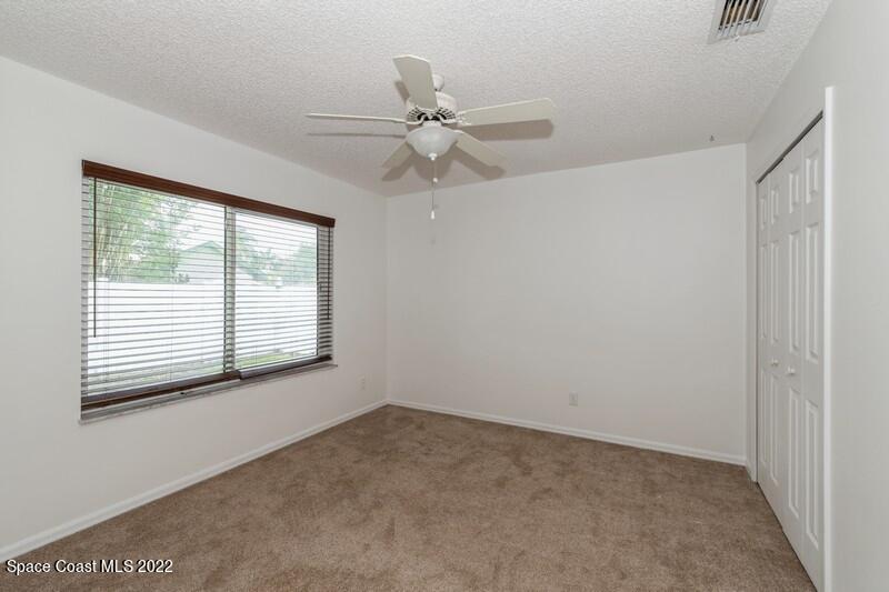 711 Montclair Road Northeast Palm Bay, FL 32905 - Photo 24 of 35 a view of an empty room with a window