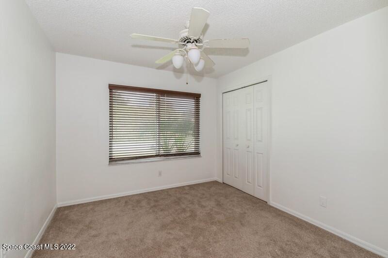 711 Montclair Road Northeast Palm Bay, FL 32905 - Photo 25 of 35 an empty room with a window and a fan