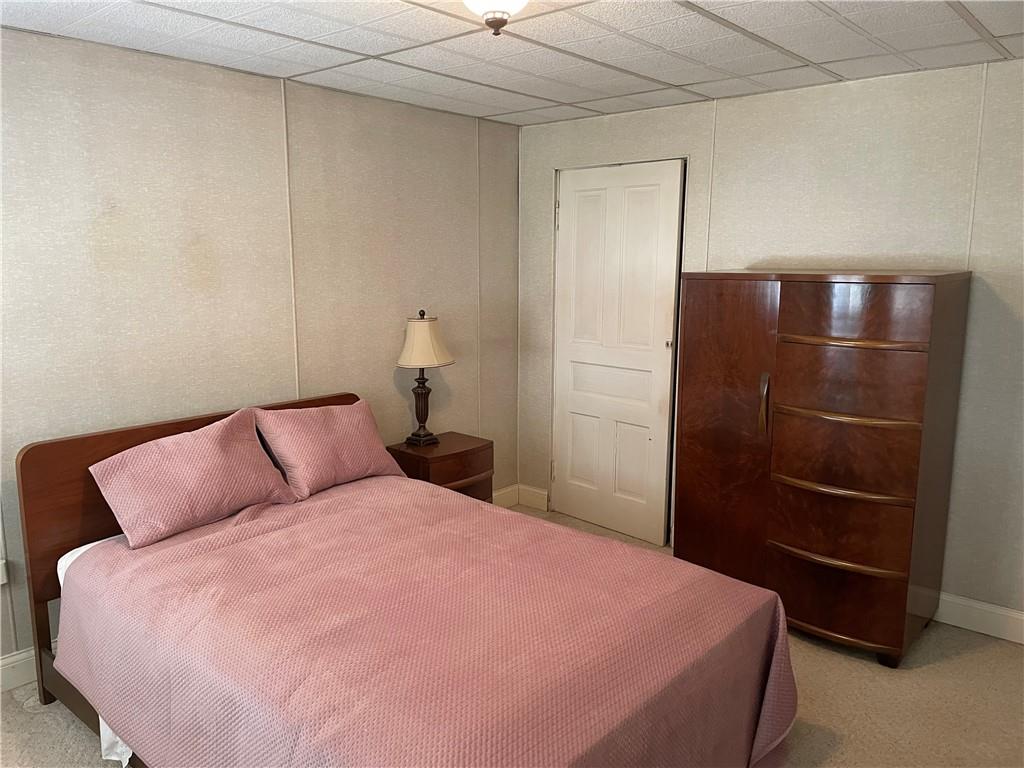 831 Railroad Street McKees Rocks, PA 15136 - Photo 11 of 16 a bedroom with a bed and a refrigerator