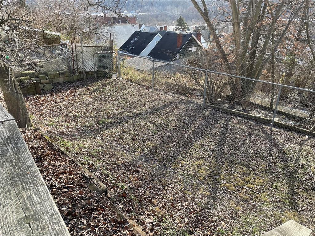 831 Railroad Street McKees Rocks, PA 15136 - Photo 5 of 16 a backyard of a house with lots of green space