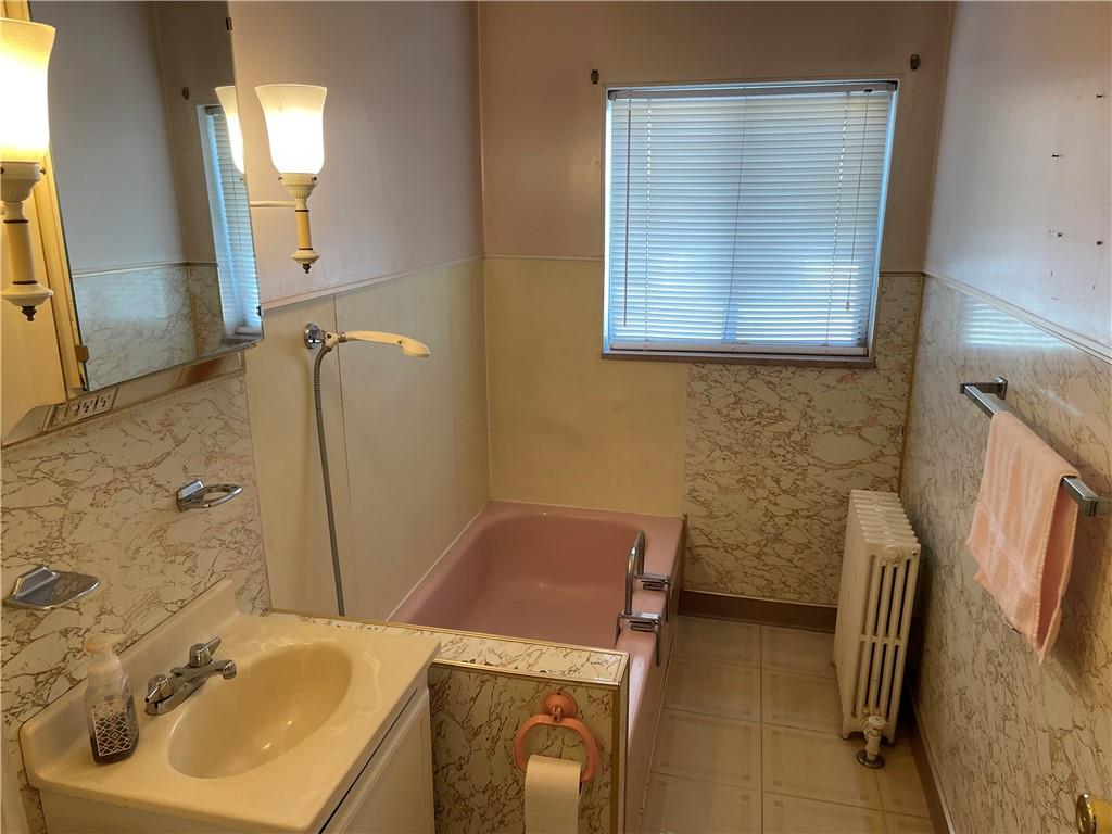 831 Railroad Street McKees Rocks, PA 15136 - Photo 9 of 16 a bathroom with a sink a toilet and a mirror