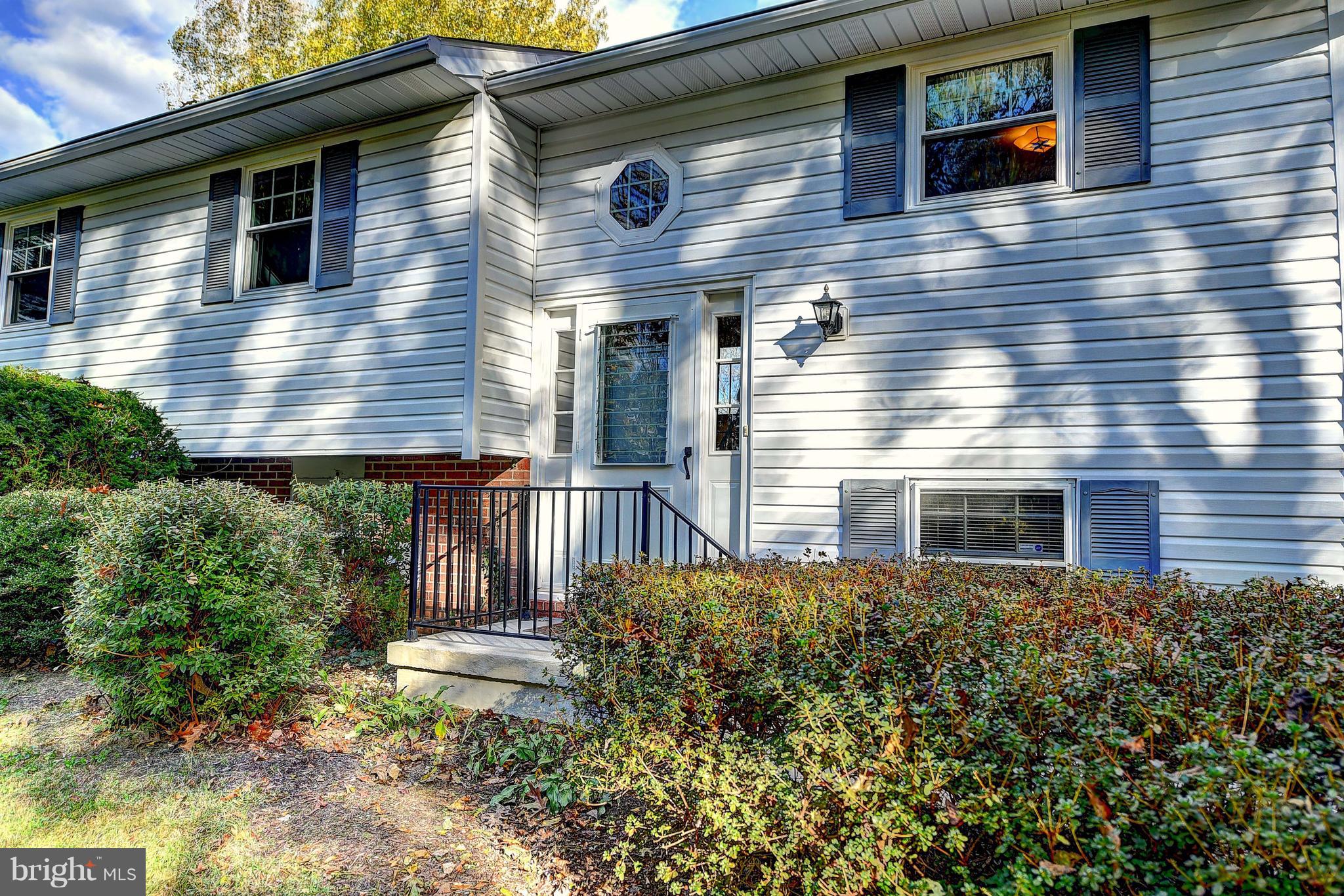 9200 Dogwood Road Baltimore, MD 21244 - Photo 2 of 25 a view of a house with brick walls and potted plants