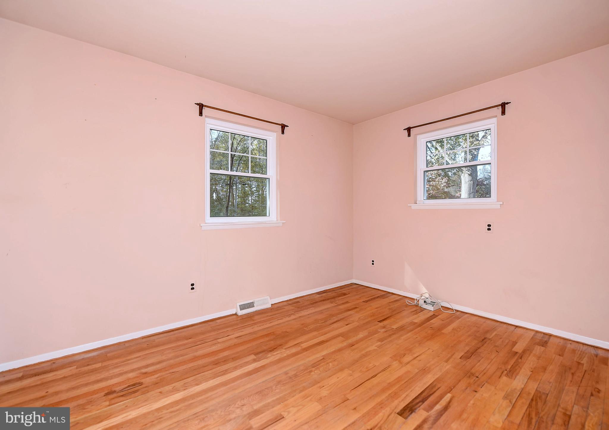 9200 Dogwood Road Baltimore, MD 21244 - Photo 11 of 25 an empty room with wooden floor and windows