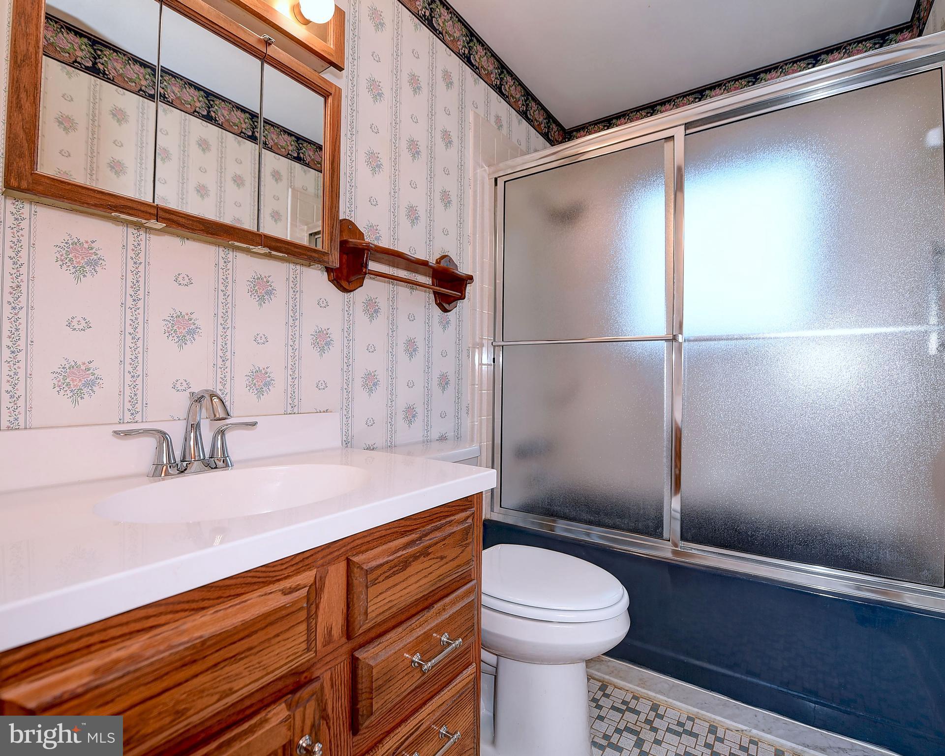 9200 Dogwood Road Baltimore, MD 21244 - Photo 14 of 25 a bathroom with a sink a toilet and shower