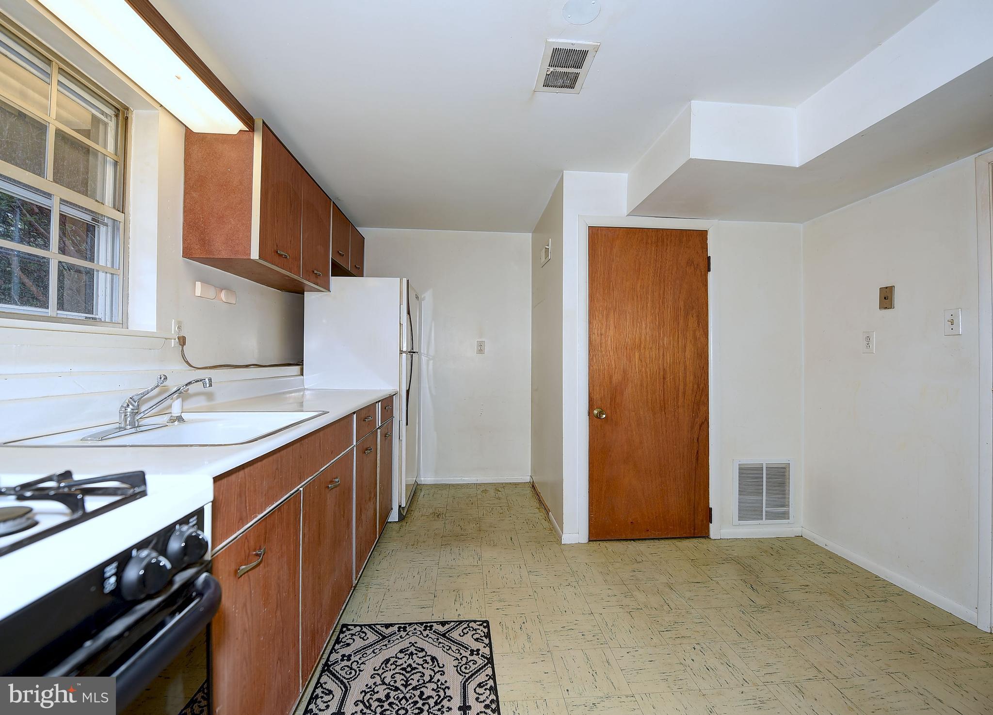 9200 Dogwood Road Baltimore, MD 21244 - Photo 18 of 25 a kitchen with stainless steel appliances granite countertop a sink stove and cabinets