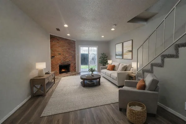 a living room with furniture potted plant and a fireplace