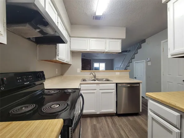 a kitchen with a stove and a refrigerator