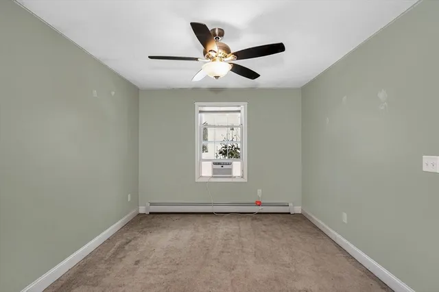 an empty room with closet and a chandelier fan