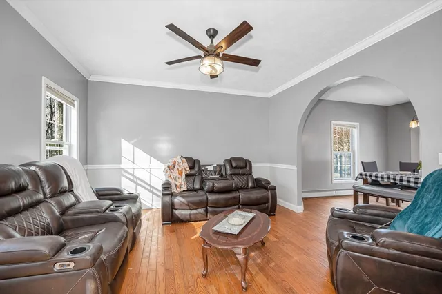 a living room with furniture and wooden floor