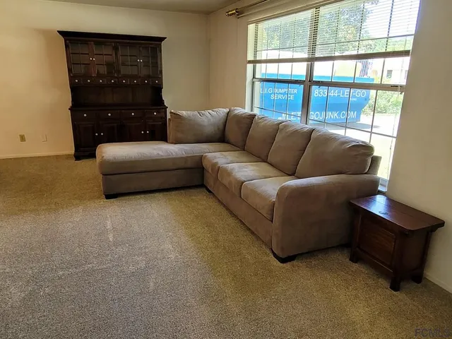 a view of a dining room with furniture and window