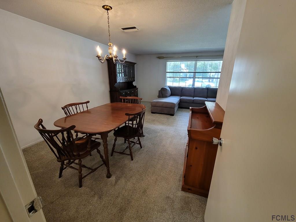 736 Lindenwood Circle Ormond Beach, FL 32174 - Photo 13 of 56 a view of a dining room with furniture and window