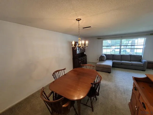 a view of a dining room with furniture and window