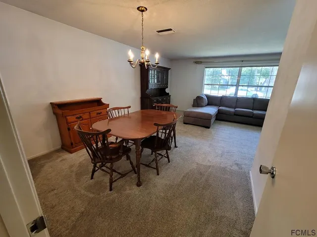 a bedroom with a bed ceiling fan and a wooden floor