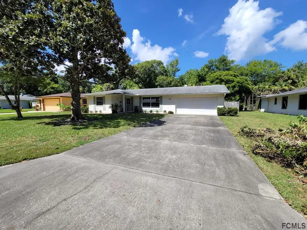 a front view of house with yard and green space