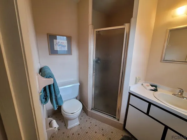 a view of a room with window and ceiling fan