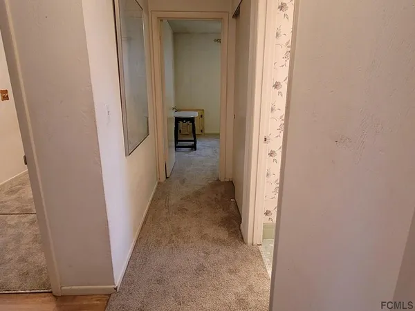 an empty room with windows and ceiling fan view