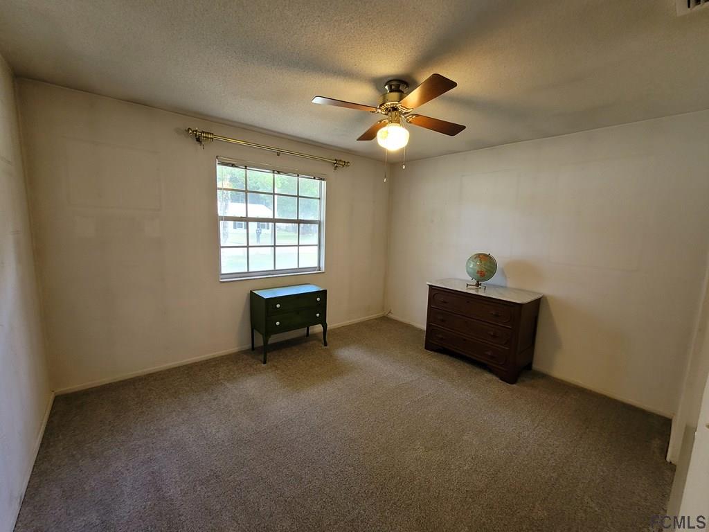 736 Lindenwood Circle Ormond Beach, FL 32174 - Photo 24 of 56 a view of a room with window and ceiling fan