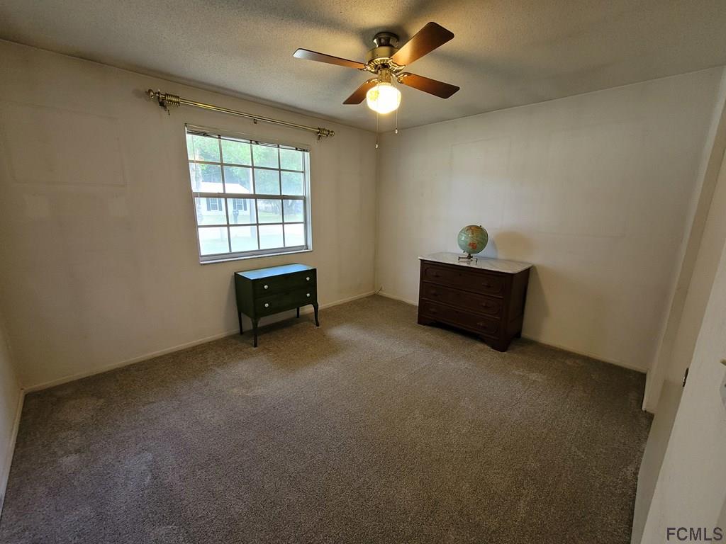 736 Lindenwood Circle Ormond Beach, FL 32174 - Photo 27 of 56 an empty room with windows and ceiling fan view