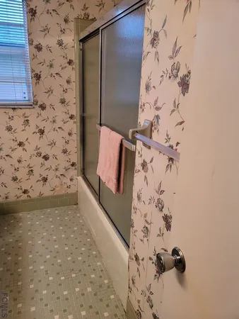 a view of room with window and a ceiling fan