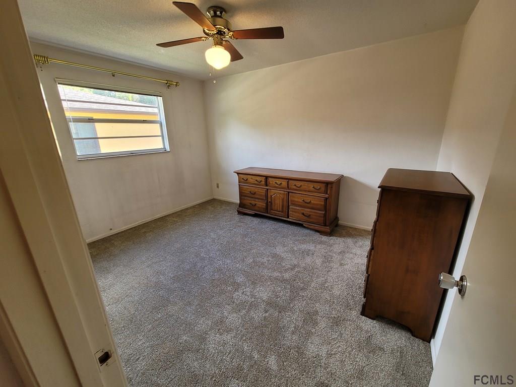 736 Lindenwood Circle Ormond Beach, FL 32174 - Photo 34 of 56 a view of room with window and a ceiling fan