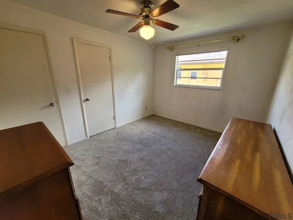 a kitchen with stainless steel appliances cabinets a sink and a large window