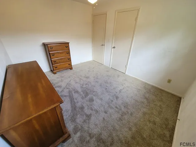 a kitchen with stainless steel appliances granite countertop a refrigerator a stove and a sink with wooden floor