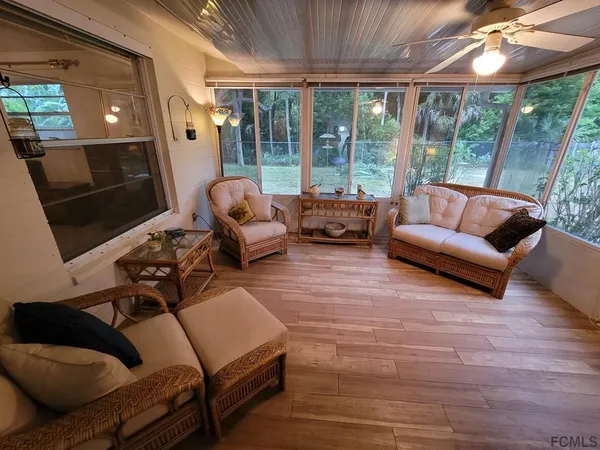 a backyard of a house with a swing and plants