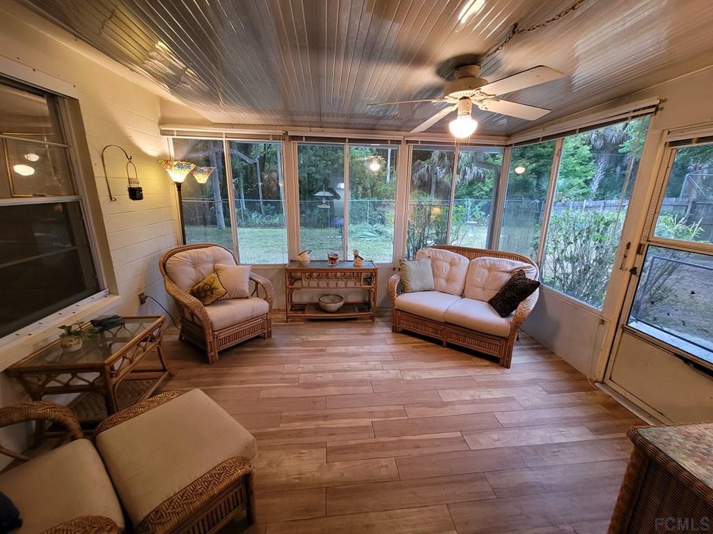 736 Lindenwood Circle Ormond Beach, FL 32174 - Photo 48 of 56 a living room with furniture and a large window