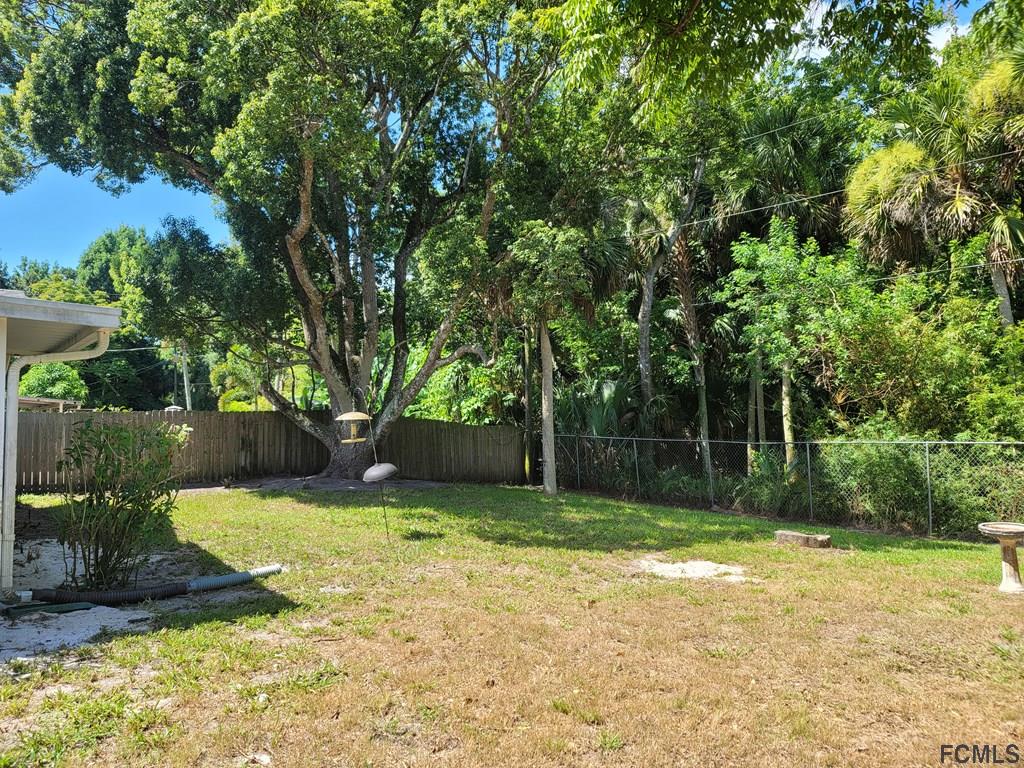 736 Lindenwood Circle Ormond Beach, FL 32174 - Photo 56 of 56 a view of a backyard with large trees