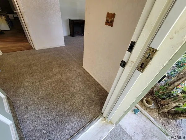 a view of a livingroom with furniture and chandelier