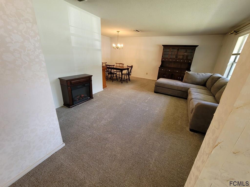 736 Lindenwood Circle Ormond Beach, FL 32174 - Photo 9 of 56 a living room with furniture and a couch
