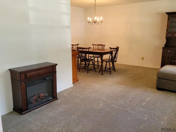 a living room with furniture and a lamp
