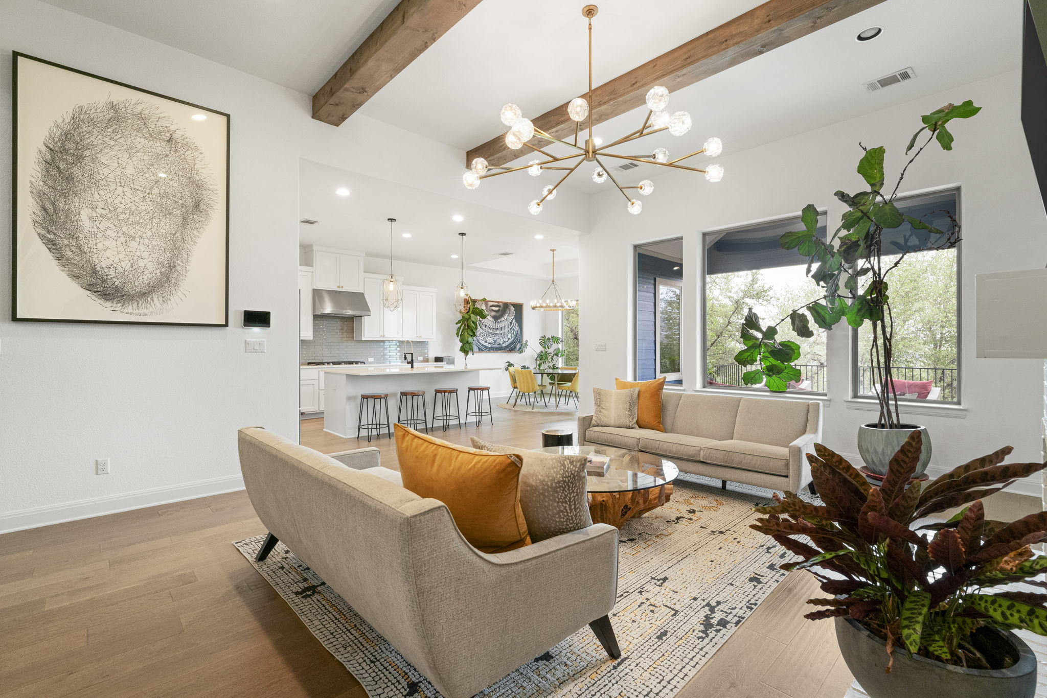 288 Hazy Hills Loop Dripping Springs, TX 78620 - Photo 12 of 40 The living area showcases designer light fixtures, natural light, and a seamless connection to the kitchen.