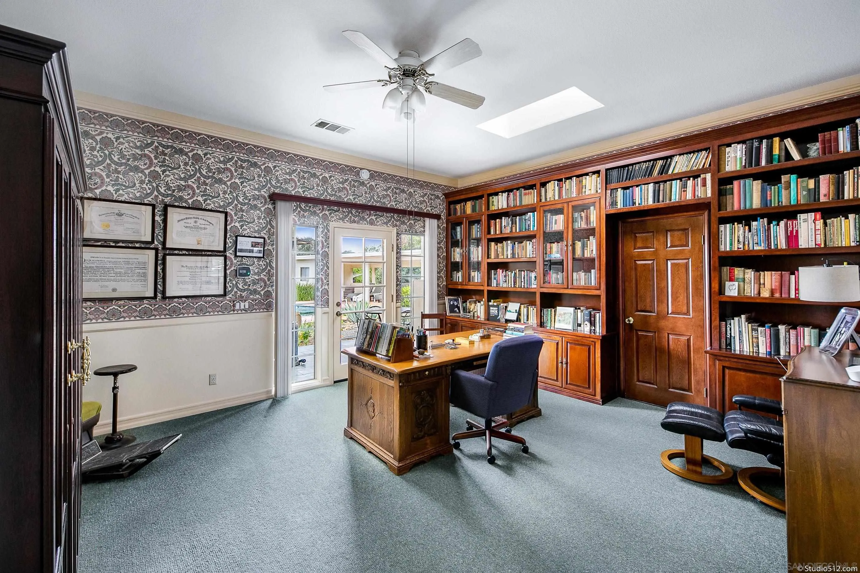 28398 Alamar Road Valley Center, CA 92082 - Photo 13 of 41 a view of a workspace with furniture and a bookshelf