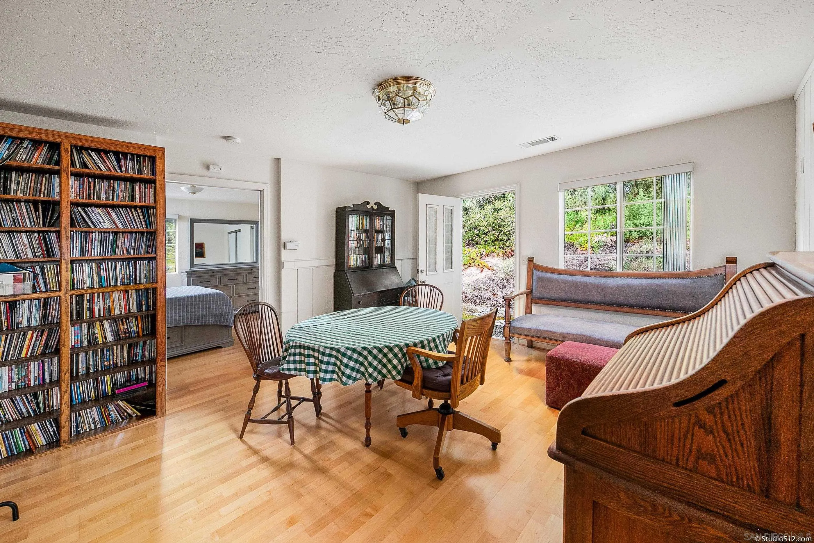 28398 Alamar Road Valley Center, CA 92082 - Photo 30 of 41 a living room with furniture and a book shelf