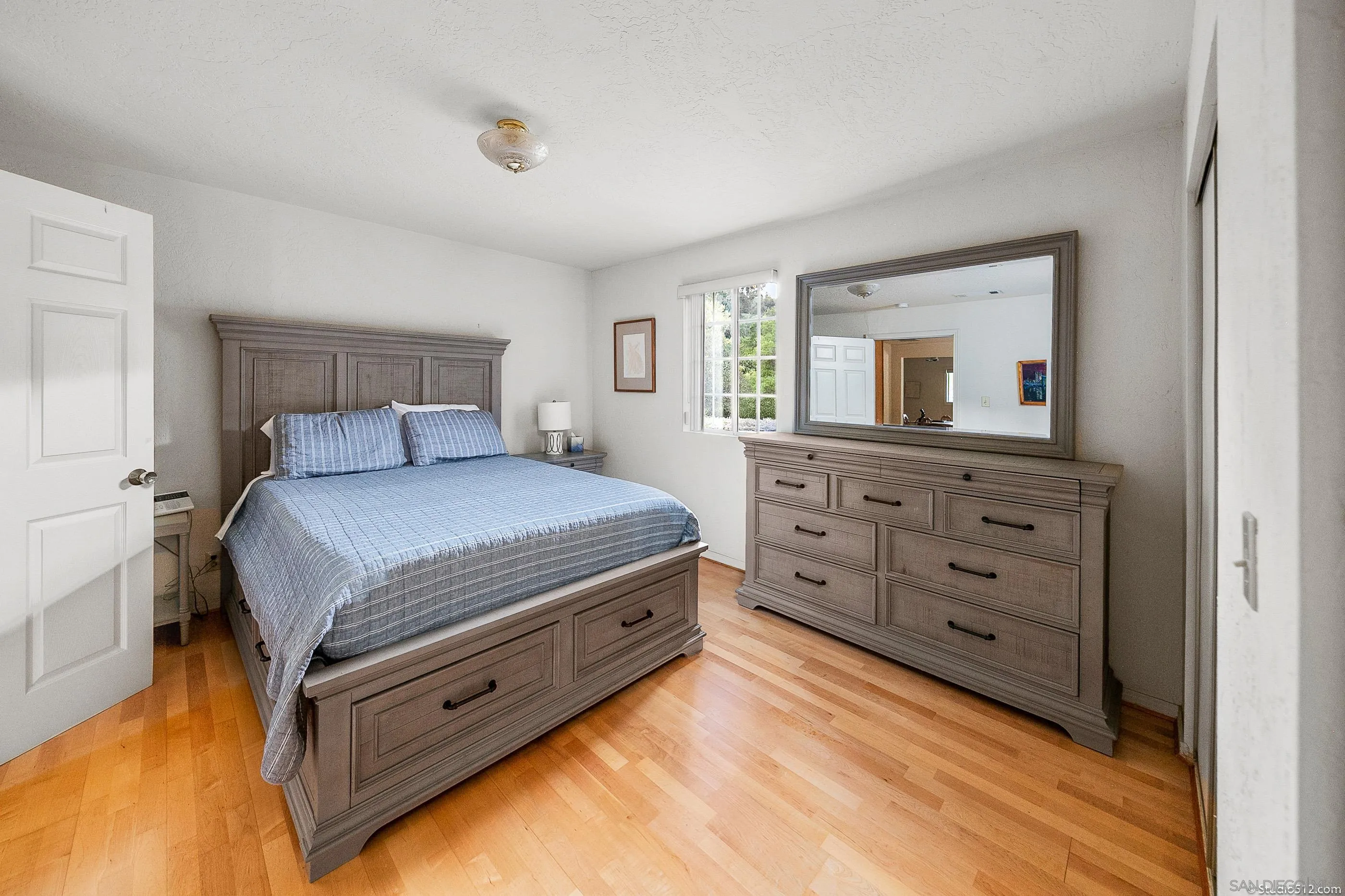 28398 Alamar Road Valley Center, CA 92082 - Photo 31 of 41 a bedroom with a bed and a dresser