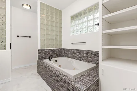 a bathroom with a bathtub and shower