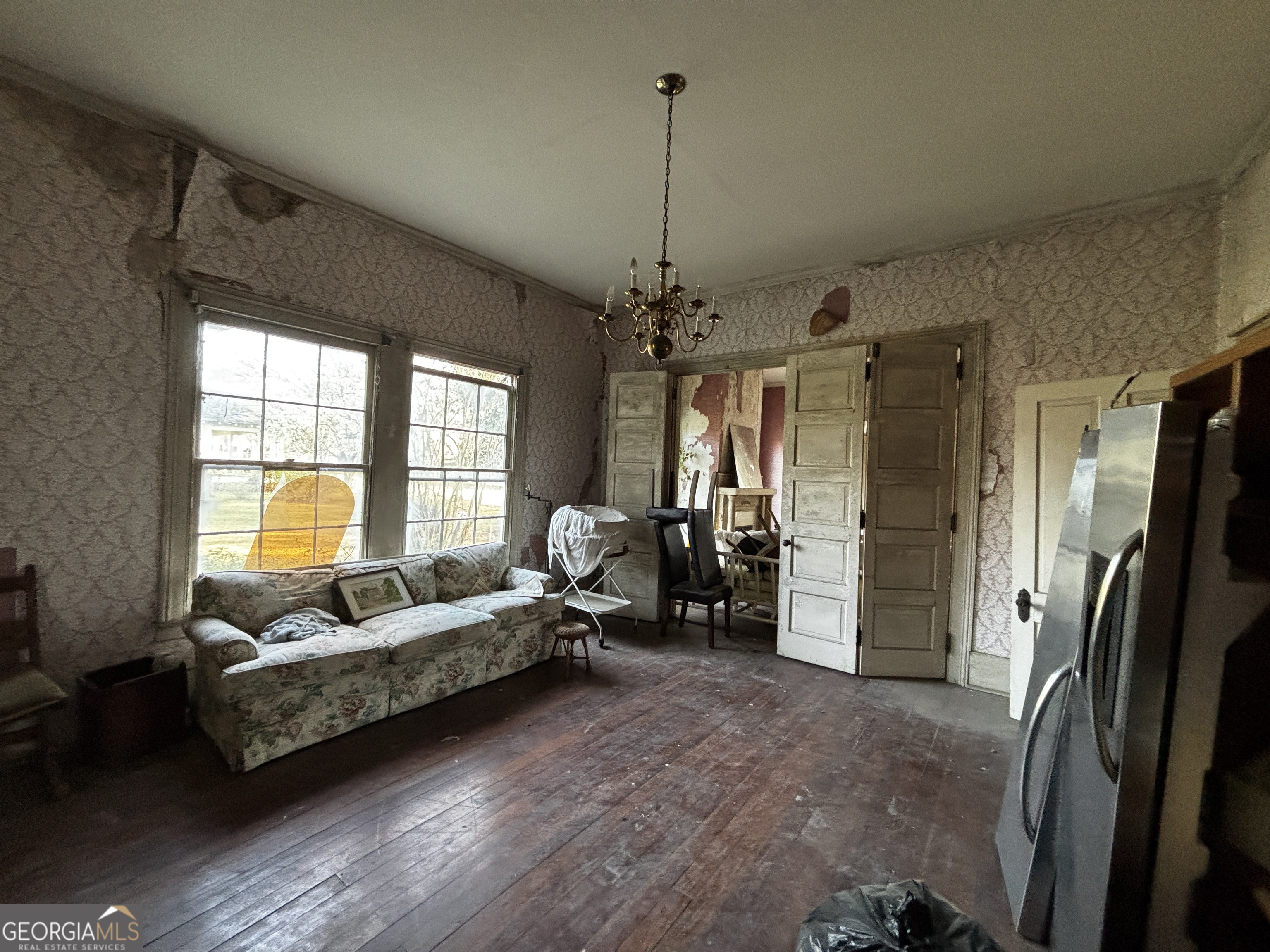 301 Cleveland Street Thomson, GA 30824 - Photo 14 of 17 a living room with furniture and a chandelier