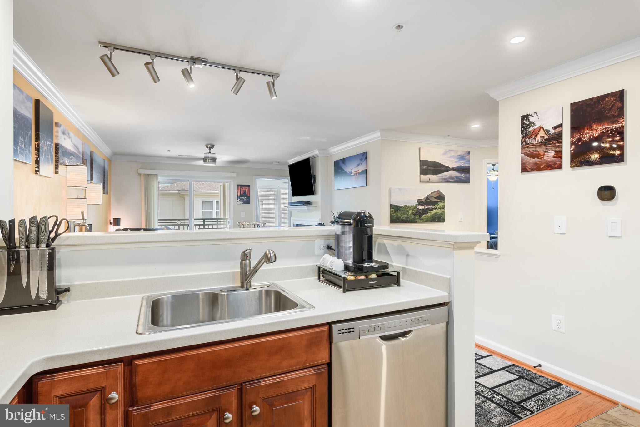 12001 Market Street, Unit 436 Reston, VA 20190 - Photo 7 of 28 Corian countertops with breakfast bar