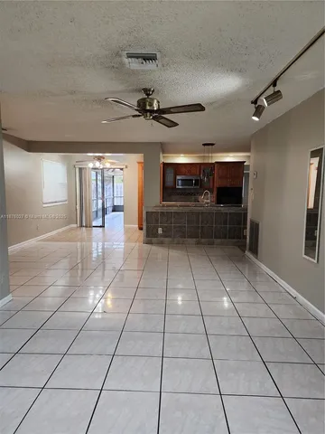 a view of a entryway with stairs and a refrigerator